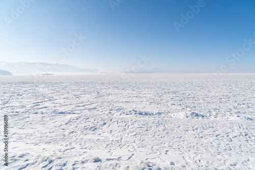 Snow covered frozen ice lake located in Xinjiang China Sayram lake. Winter season. © Jiva Core