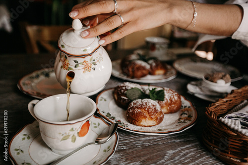 Two girls drink tea in a restaurant with custard buns / big plan