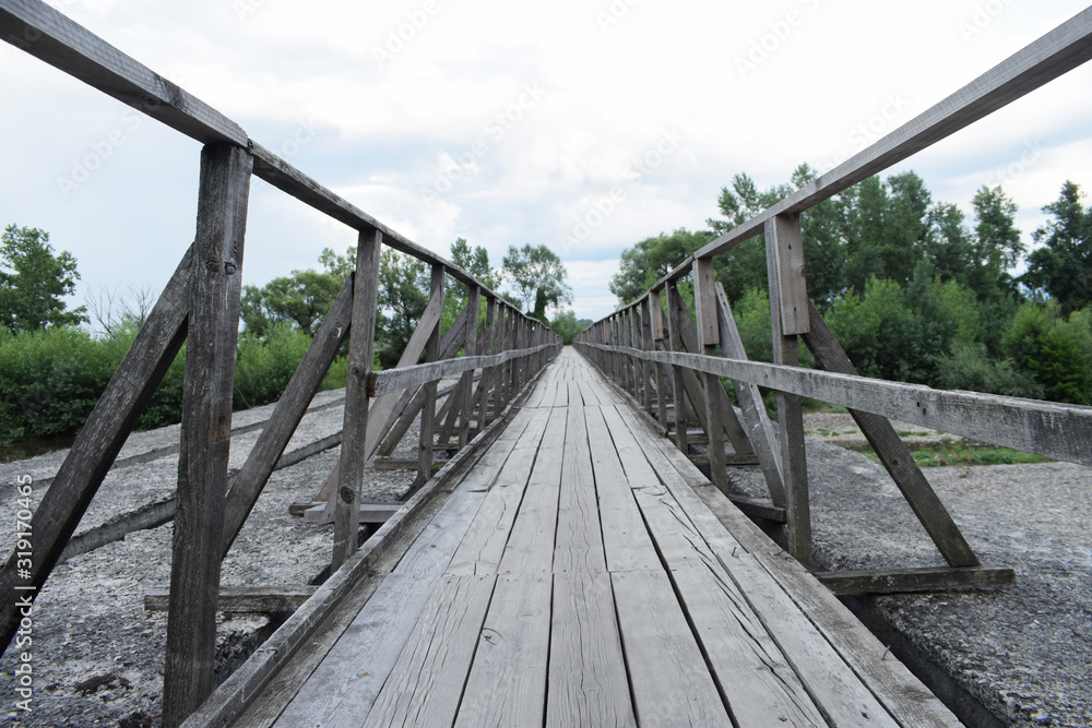 Suspended wooden bridge in black and white