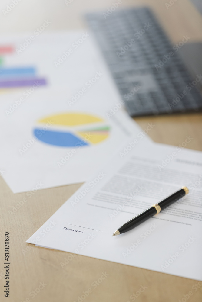 Document, pen at foreground, blurred background.. Document, pen at foreground, blurred background..
