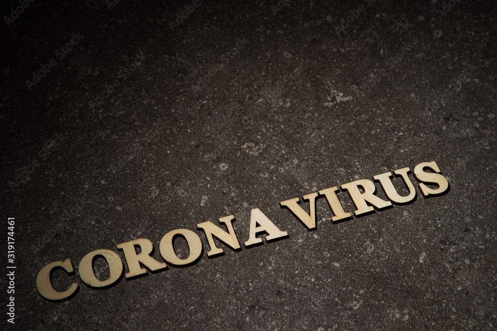 Fototapeta premium Word coronavirus on stone texture background