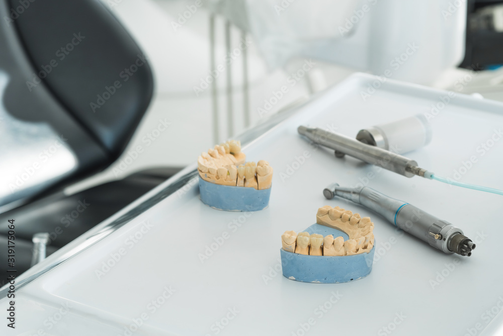 Artificial chew with made tooth crowns is standing on the table in the dental laboratory. Technical and professional equipment. Artificial chew with made tooth crowns is standing on the table in the dental laboratory. Technical and professional equipment.