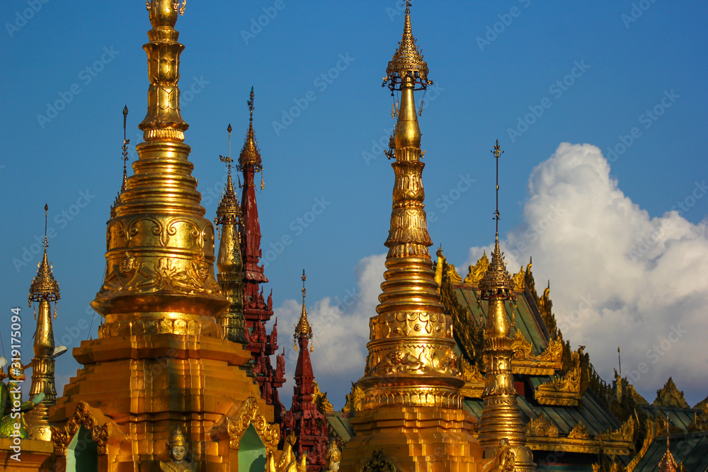 Fototapeta premium Gold-plated Elements of an ancient pagoda in Myanmar at sunset