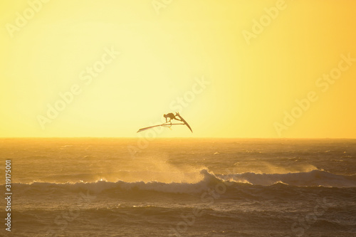Windsurfing high jump at sunset