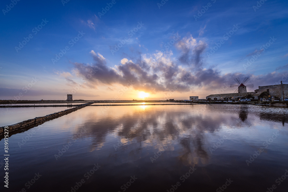 Picturesque sunset over Nubia saltworks nature protected area in Nubia village near Trapani city on Sicily Island in Italy Picturesque sunset over Nubia saltworks nature protected area in Nubia village near Trapani city on Sicily Island in Italy