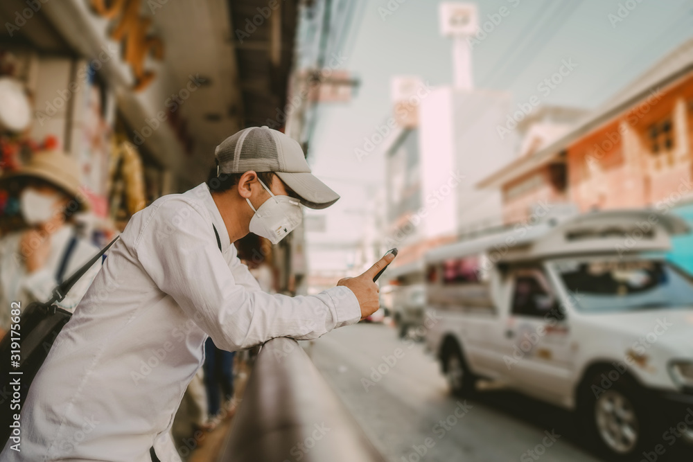 Man wearing a mask to protect against viruses and dust on the street,corona and pm2.5 concept. Man wearing a mask to protect against viruses and dust on the street,corona and pm2.5 concept.