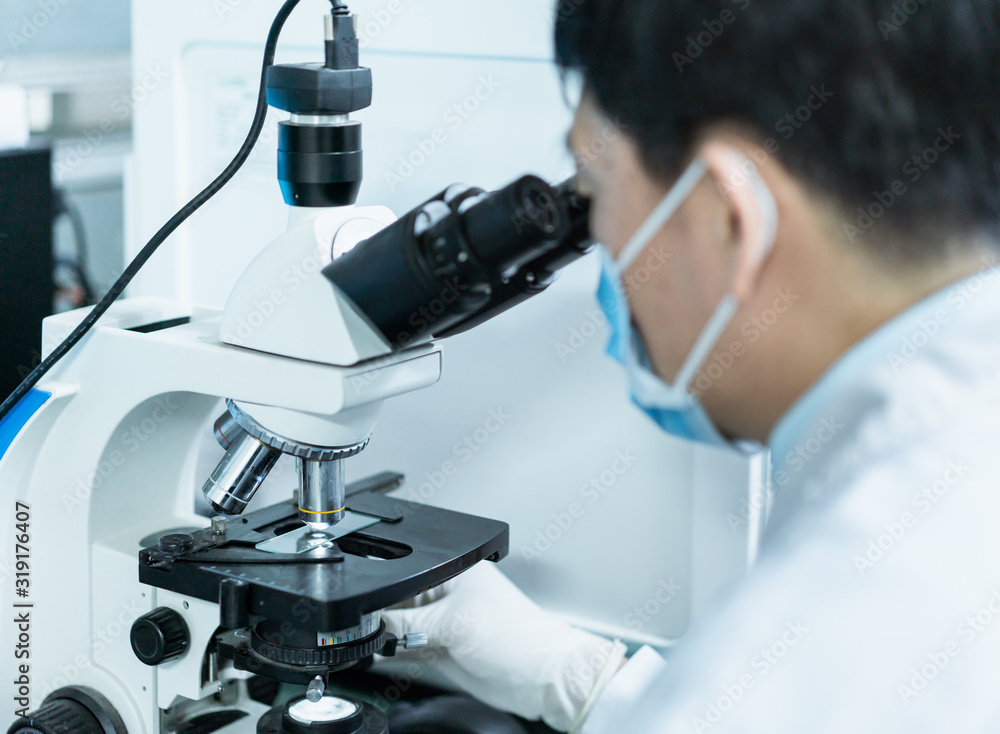 Doctor is using microscope to observe samples Doctor is using microscope to observe samples
