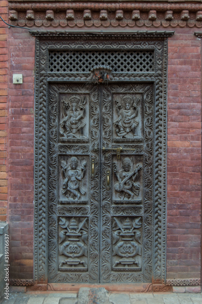 Wooden carved door in a temple at Durbar Square, Bhaktapur, Nepal Wooden carved door in a temple at Durbar Square, Bhaktapur, Nepal