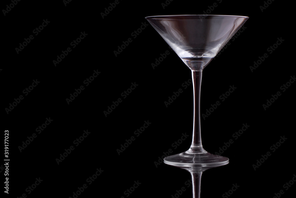 empty martini glass on black background empty martini glass on black background