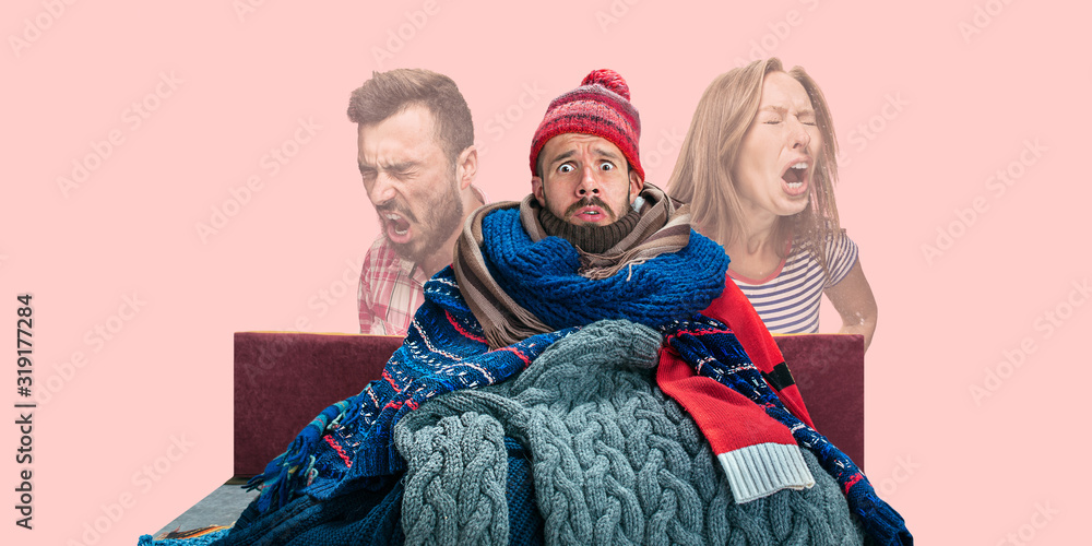 Young caucasian man feeling ill, has virus infection, fever, headache and sneezing. Wearing a bunch of clothing. Scared to have coronavirus. Concept of healthcare, medicine, epidemy, treatment. Flyer. Young caucasian man feeling ill, has virus infection, fever, headache and sneezing. Wearing a bunch of clothing. Scared to have coronavirus. Concept of healthcare, medicine, epidemy, treatment. Flyer.