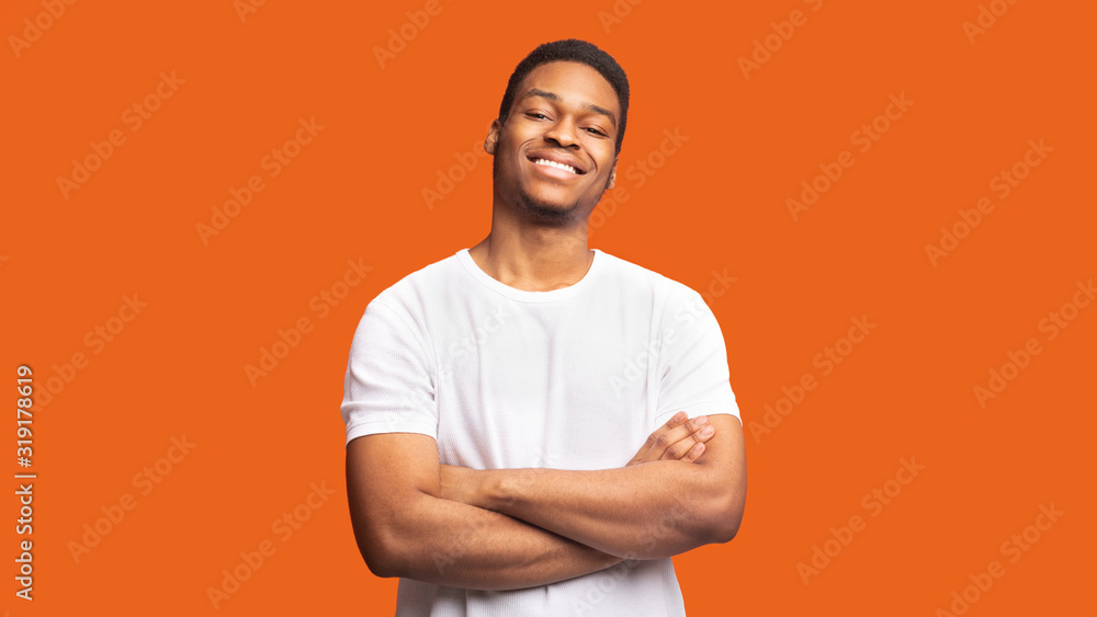Smiling afro guy portrait on orange background Smiling afro guy portrait on orange background
