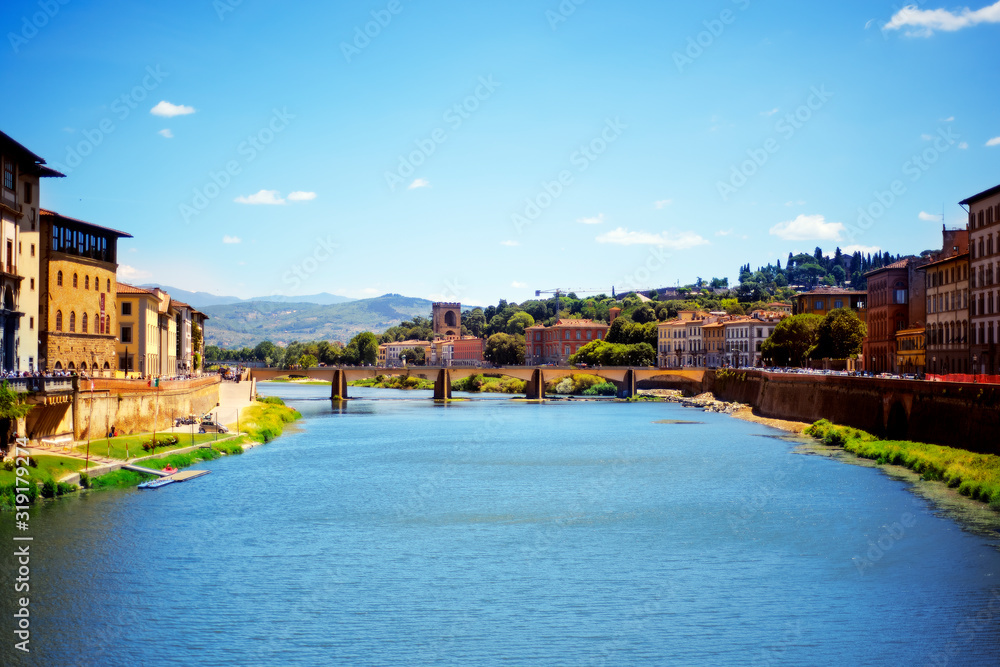 View on old bridge, water of Arno river, blue sky in Florence, Tuscany, Italy in day time in summer. Florence one of the most famous popular touristic city of Italy. View from Uffizi gallery window.