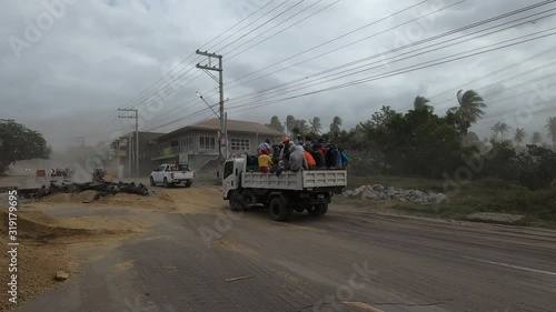 Taal Volcano Crisis - Truck Loaded With People Drives Over Damaged Road photo