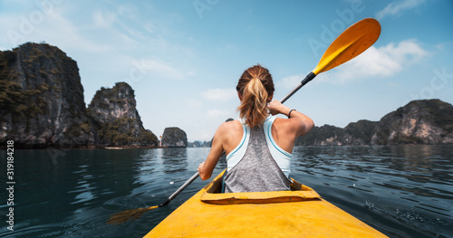Woman paddles kayak in the Ha Long Bay in Vietnam © Dudarev Mikhail