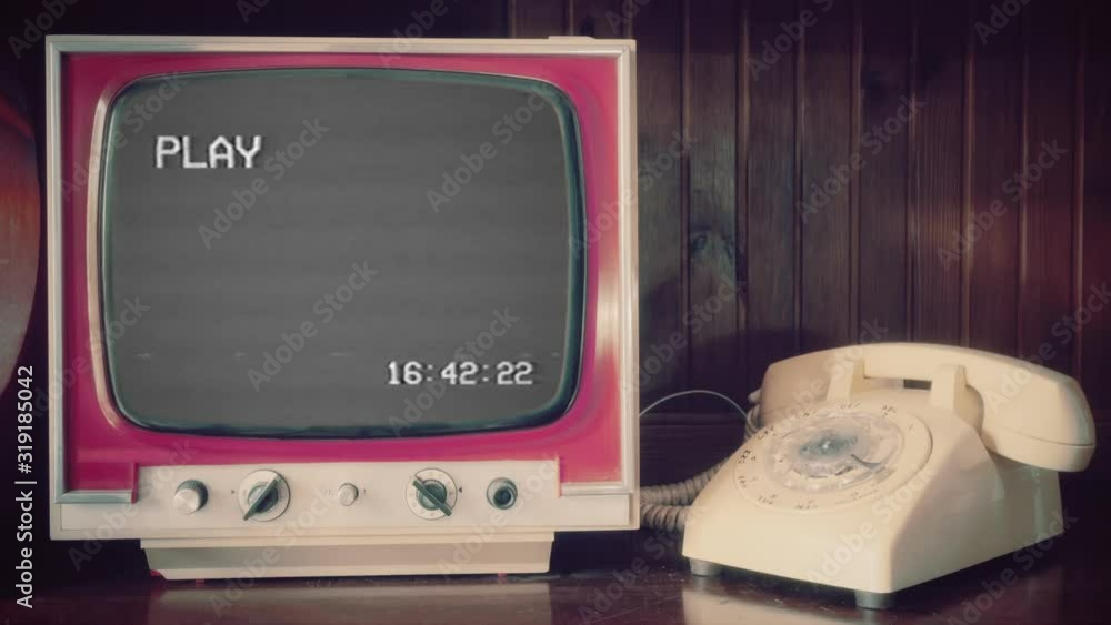 Analog scene with a rotary phone and a vintage TV showing a VHS tape playing (big text font