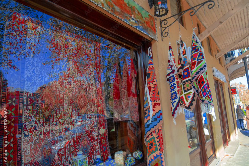 Tbilisi, Georgia, 18 December 2019 -  vintage style Oriental carpets on show case of a souvenir shop