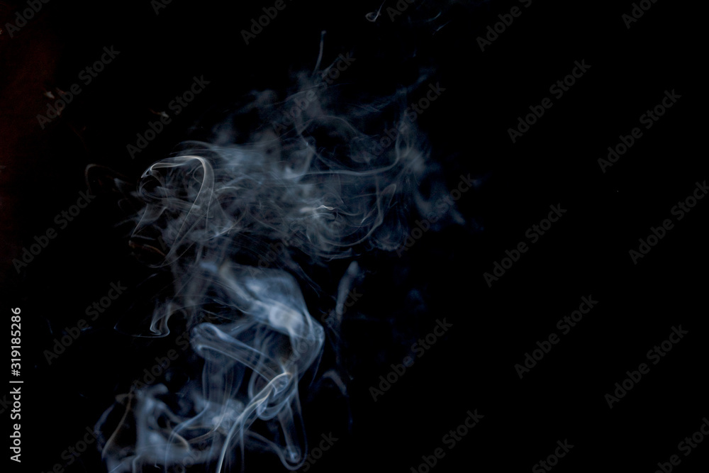 Abstract smoke from incense and light in a black background Abstract smoke from incense and light in a black background