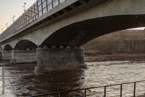 view of the river and landscape under the bridge Walk under the bridge over the Narova River in the early morning.