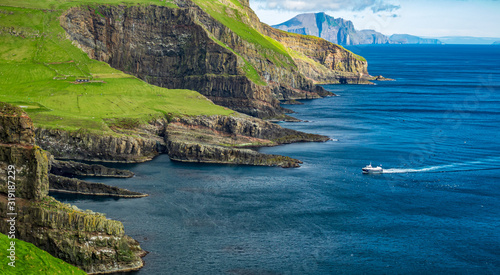 Boat arriving to Mykines island in Faroe islands photo