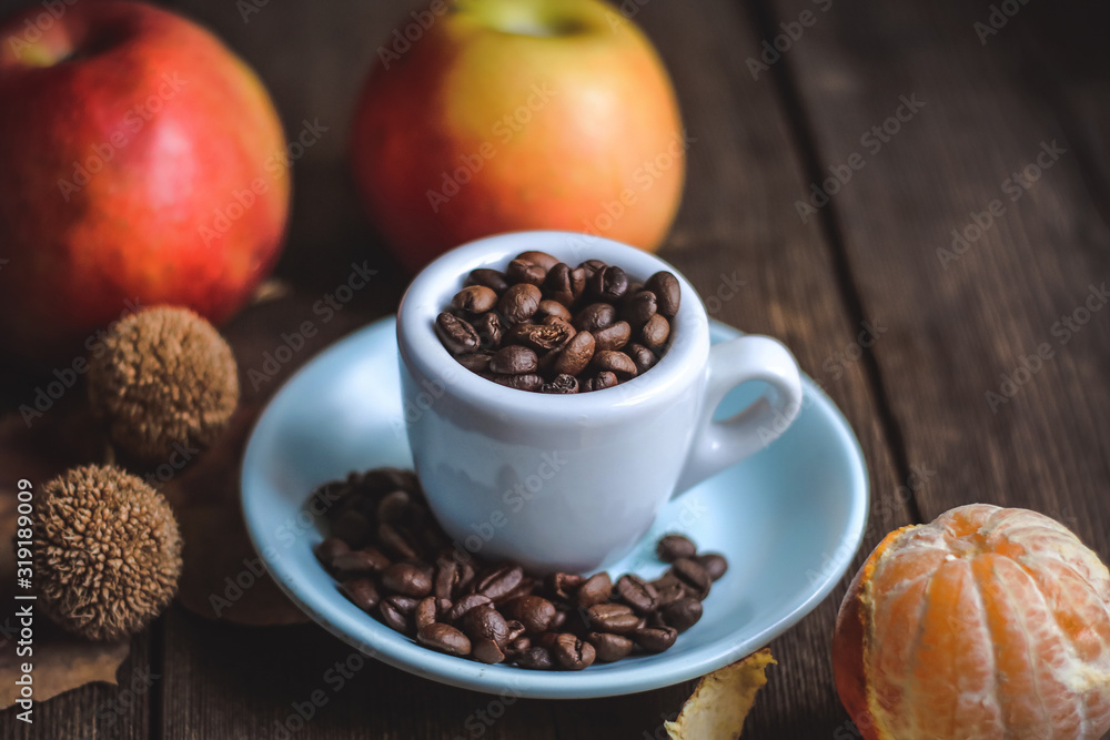 cup with coffee grains and fruits on a wooden background.. cup with coffee grains and fruits on a wooden background..