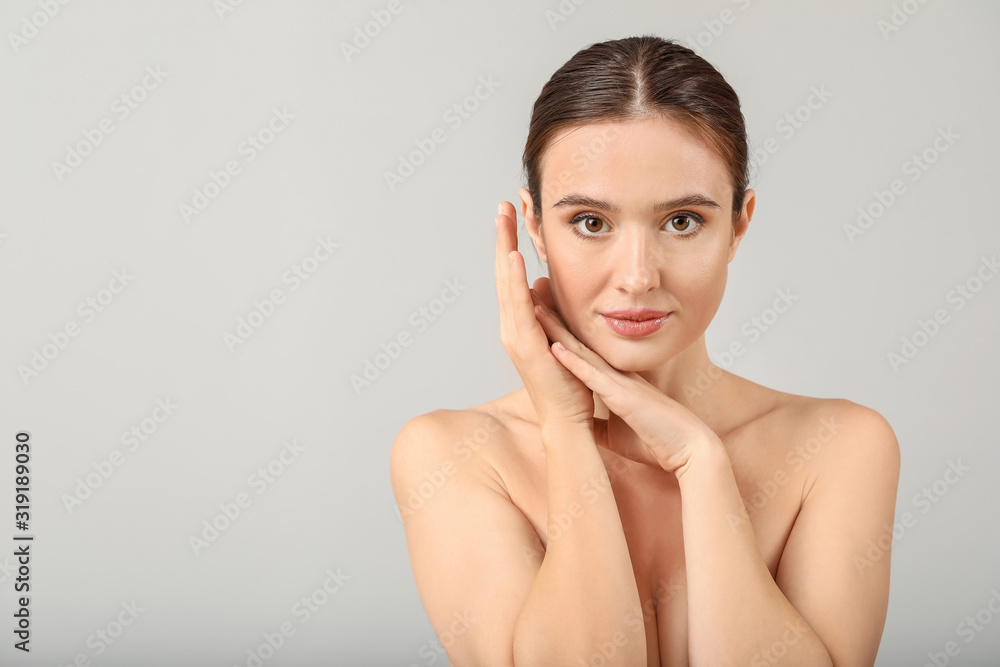 Beautiful young woman with healthy skin on light background Beautiful young woman with healthy skin on light background