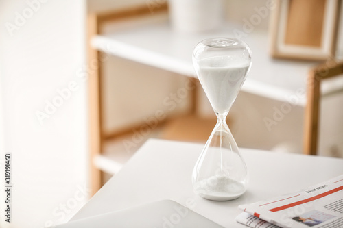 Hourglass on table in offic...