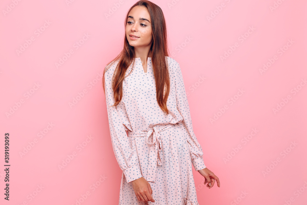 Obraz premium Young woman in a stylish dress. Girl posing on a pink background