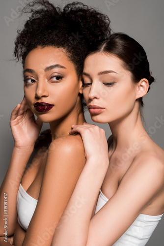portrait of beautiful multiethnic women with perfect skin, isolated on grey