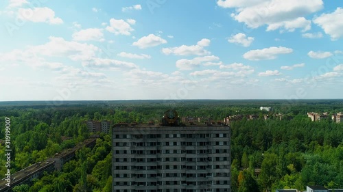 Wallpaper Mural Aerial view of abandoned buildings and streets overgrown with trees in city Pripyat near Chernobyl nuclear power plant. Exclusion Zone. Sign of USSR on the roof. 4K drone footage. Torontodigital.ca