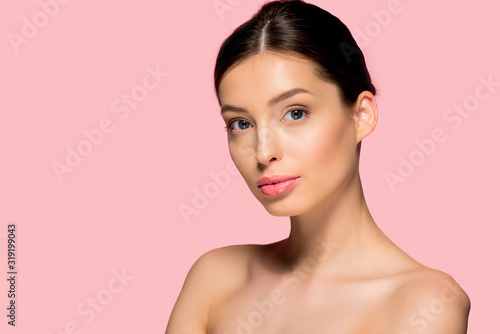 portrait of beautiful naked girl with perfect skin, isolated on pink