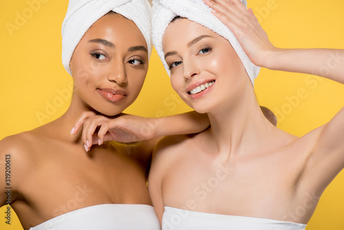 happy multiracial girls with towels on heads, isolated on yellow