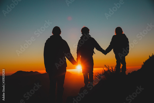 Father with kids-boy and girl- travel in sunset mountains