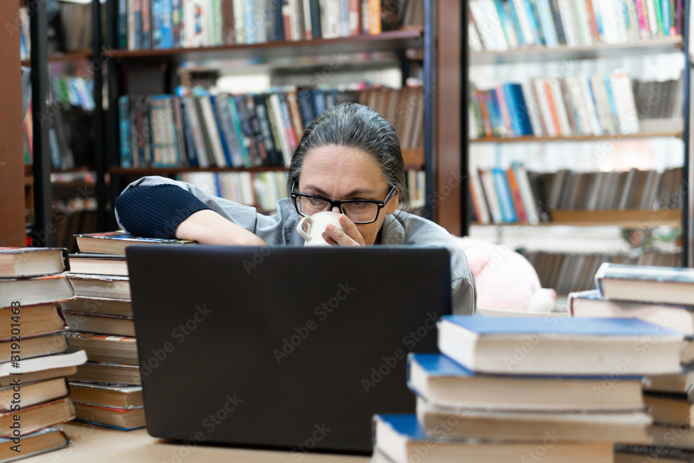 woman in the library in front of bookshelves. Concept of education woman in the library in front of bookshelves. Concept of education
