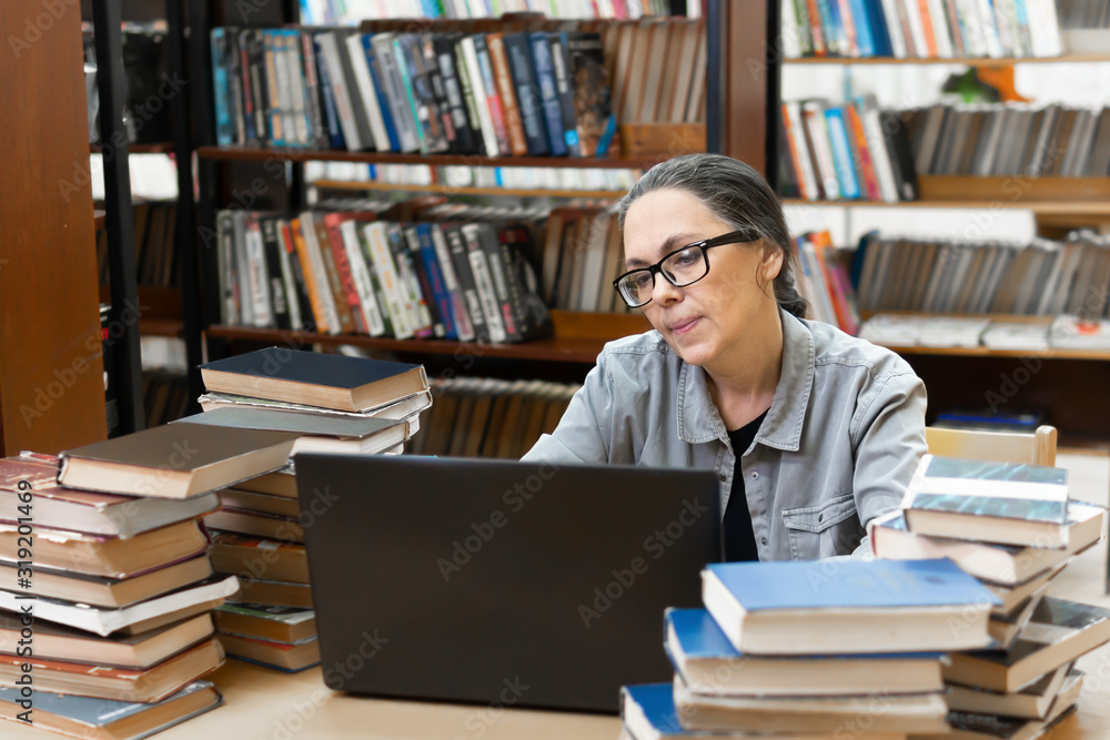 woman in the library in front of bookshelves. Concept of education woman in the library in front of bookshelves. Concept of education