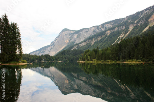 Mountains reflected in a green lake