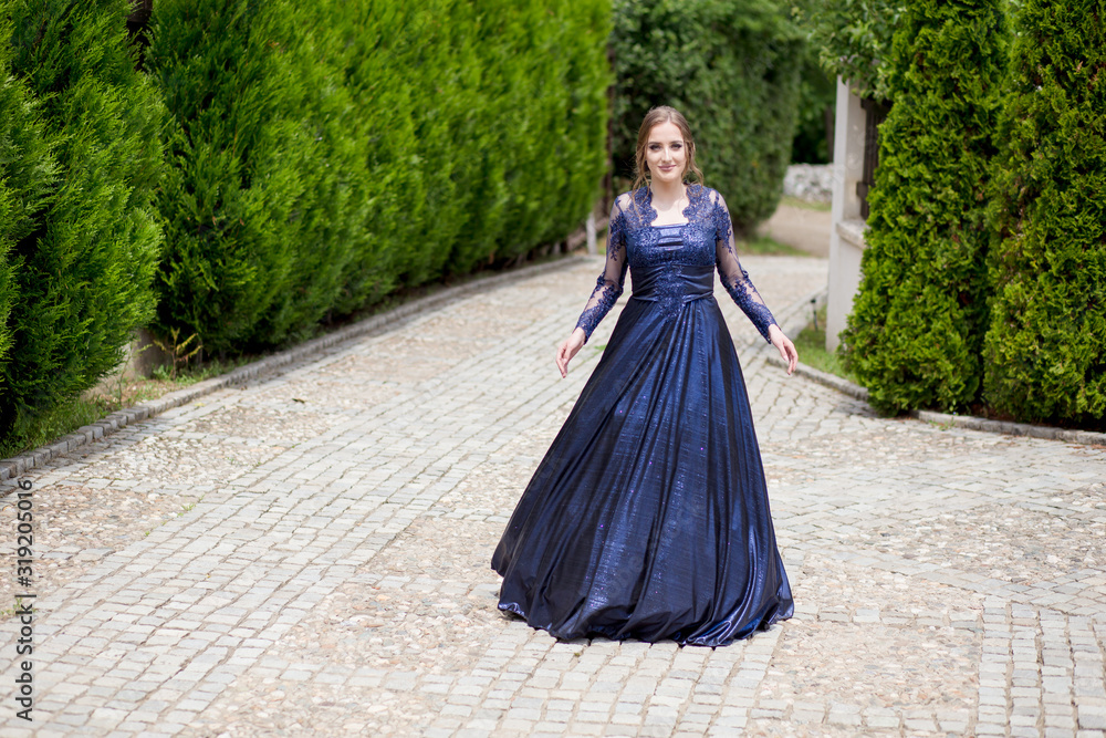Fototapeta premium Beautiful girl in glamorous ultramarine dress. Ready for her prom night.