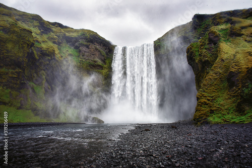 The view of amazing Sk  gafoss waterfall in Iceland in a dark rainy day