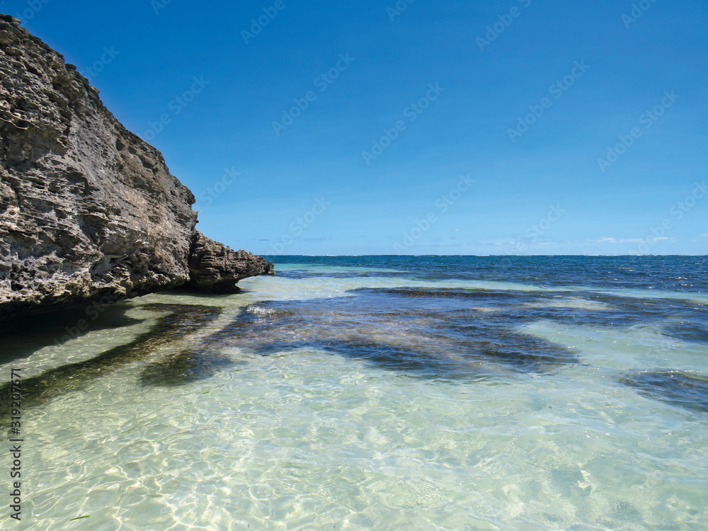 Transparent and turquoise waters of the Caribbean Sea. White sand beach and tropical blue sky. Paradise landscape. Martinique, French West Indies.