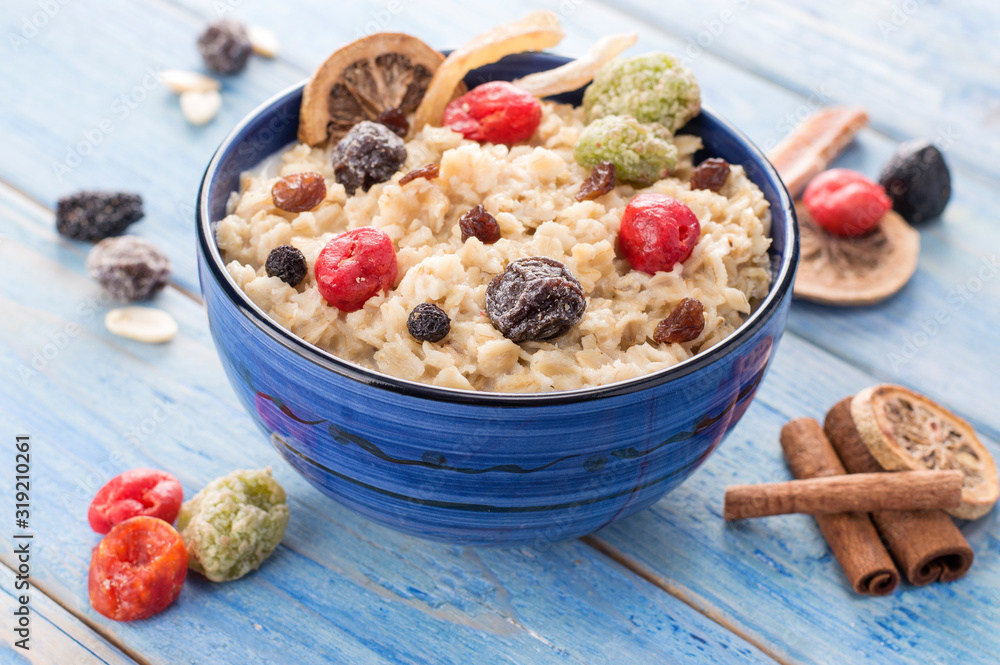 oatmeal with dried fruits on a blue wooden background oatmeal with dried fruits on a blue wooden background