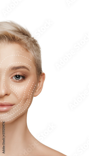 Beautiful female face with lifting up arrows isolated on white background. Concept of bodycare, cosmetics, skincare, correction surgery, beauty and perfect skin. Copyspace for your ad. Antiaging.