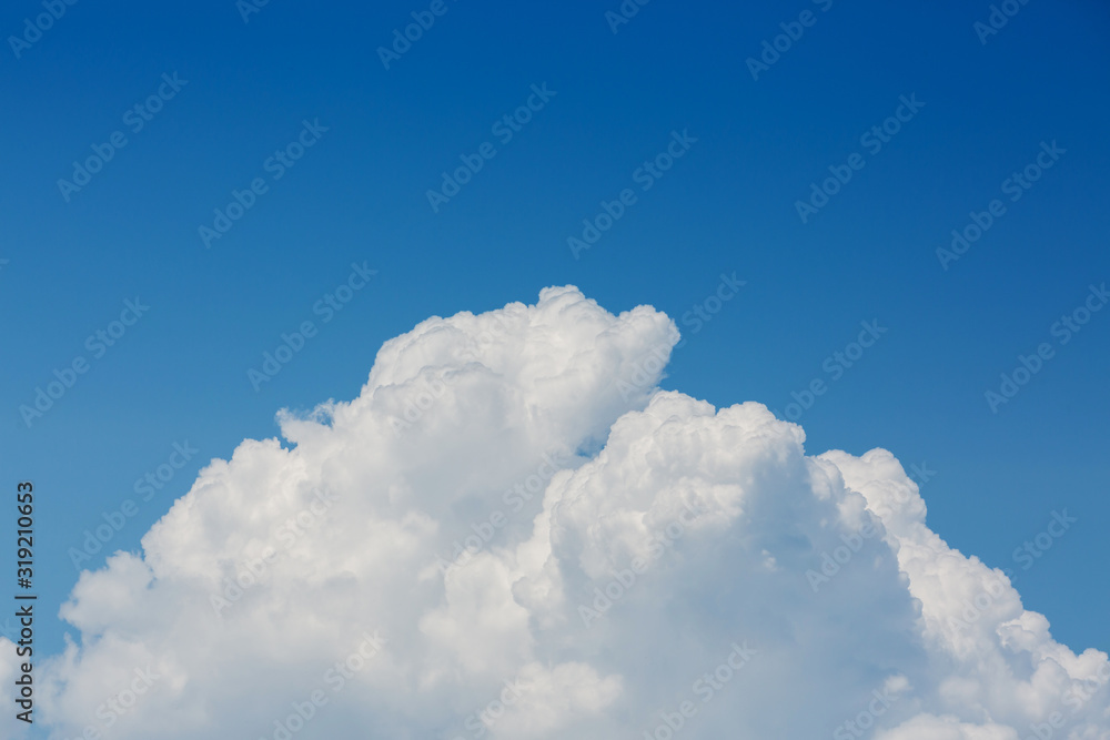 fluffy white cloud above clear blue sky background fluffy white cloud above clear blue sky background