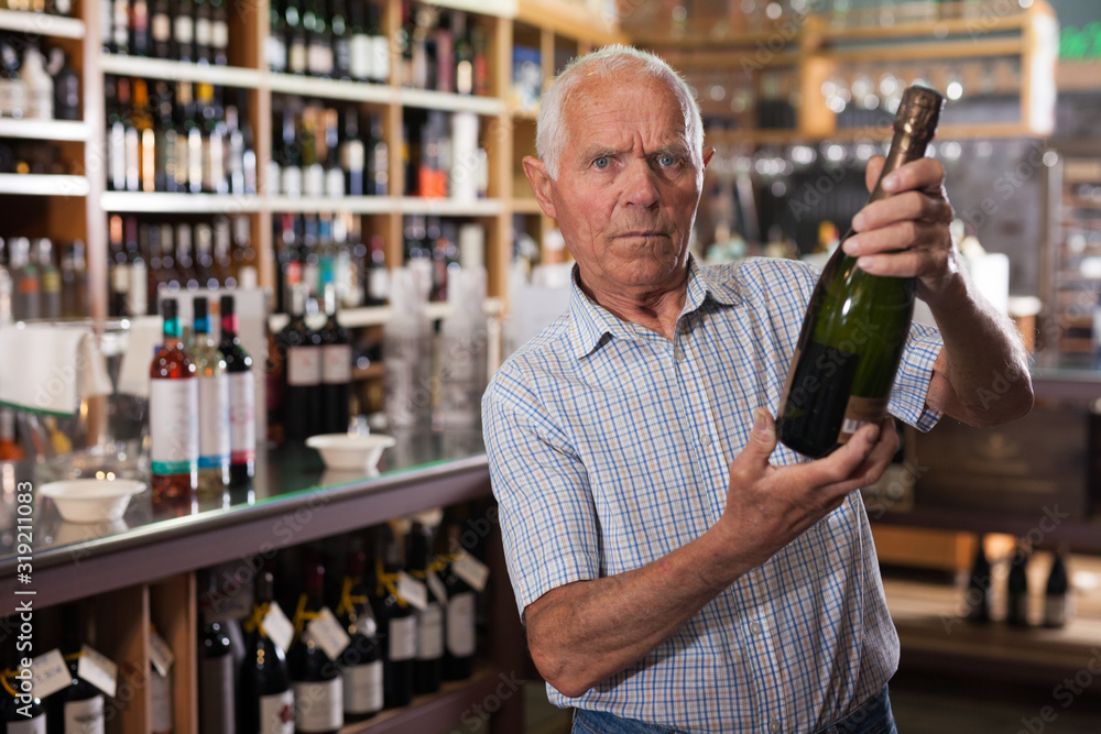 Man looking for wine in wine store