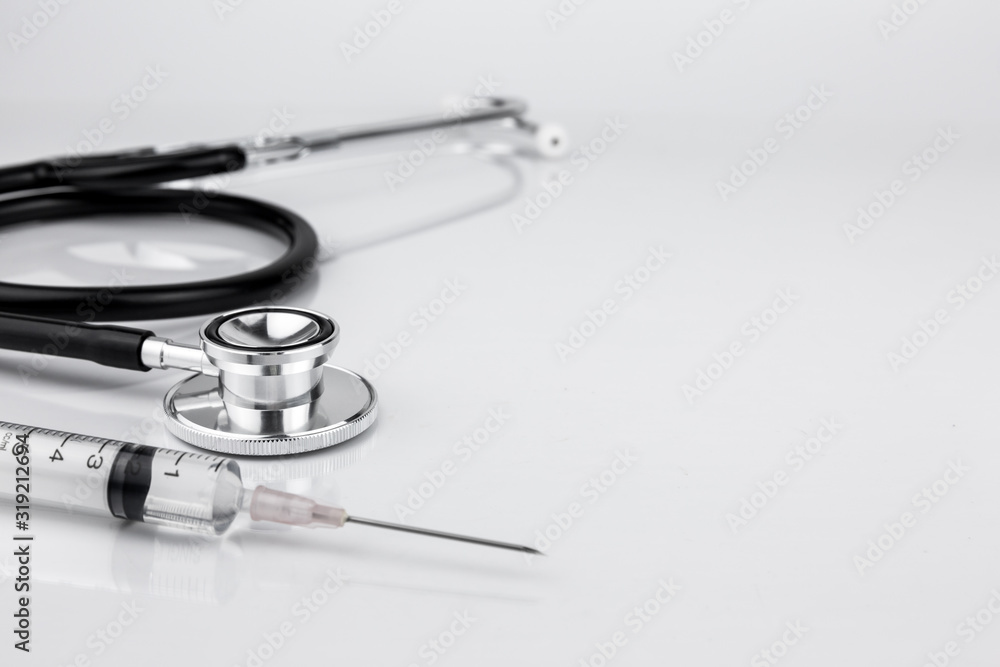 Doctor stethoscope for cardiac on white background with syringe Doctor stethoscope for cardiac on white background with syringe