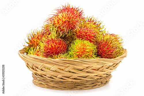 Close up fresh rambutan sweet and delicious fruit in basket isolated on white background.