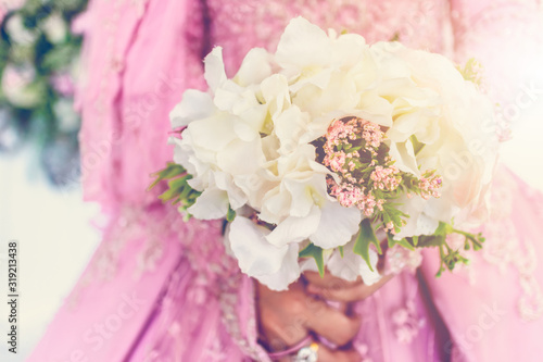 Close up bride holding bouquet of fake flower wedding