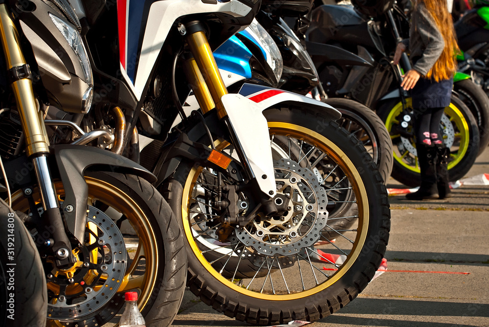 Obraz premium Motorcycle wheel closeup. Motorcycle metal parts. Biker meeting in the city.