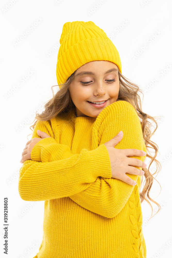 Happy caucasian girl in yellow hat and hoody smiles and rejoices isolated on white background Happy caucasian girl in yellow hat and hoody smiles and rejoices isolated on white background
