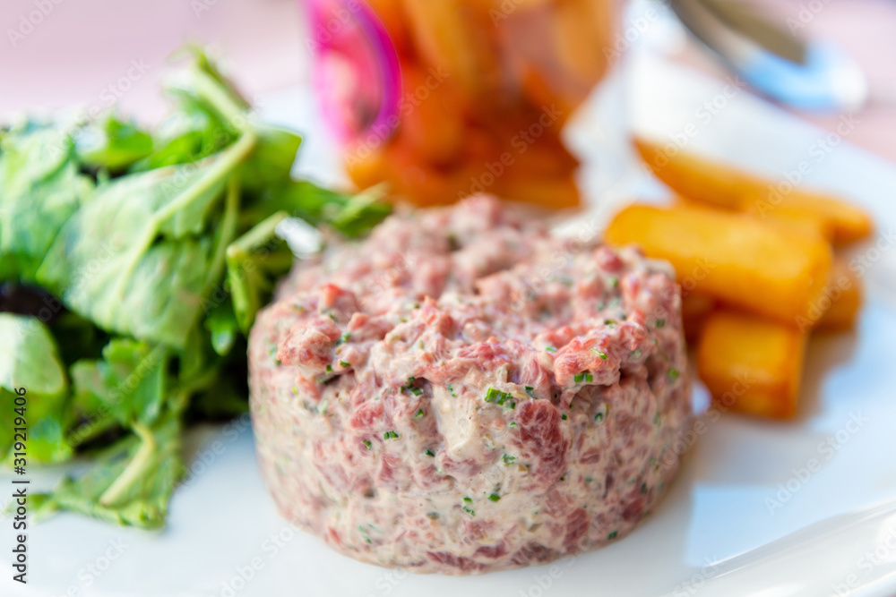 tasty Steak tartare (Raw beef) - classic steak tartare on white plate tasty Steak tartare (Raw beef) - classic steak tartare on white plate