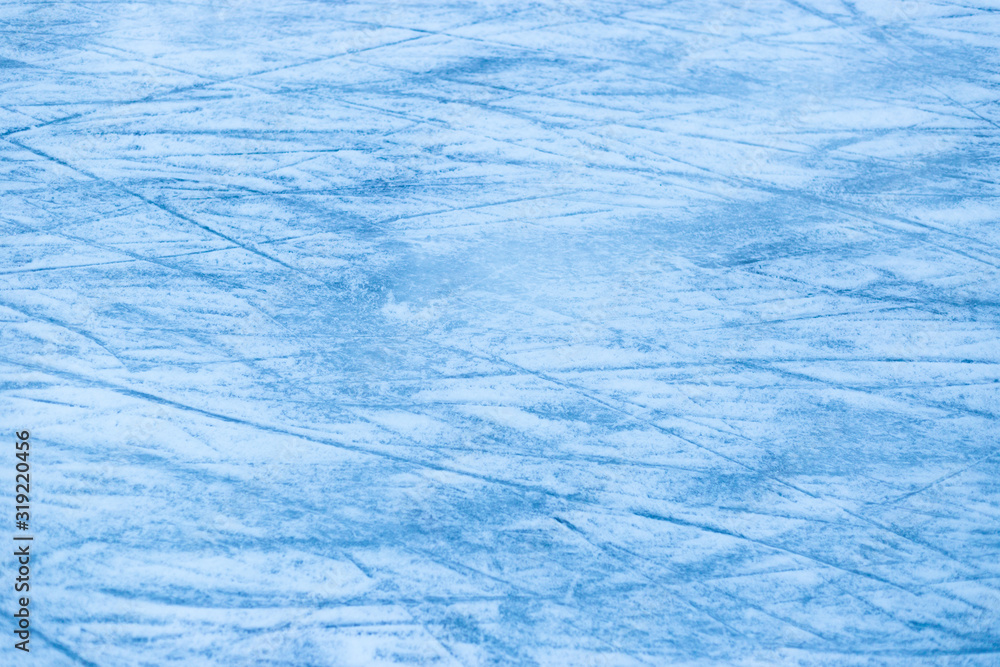 Abstract ice texture. Nature blue background. Traces of blades of skates on ice