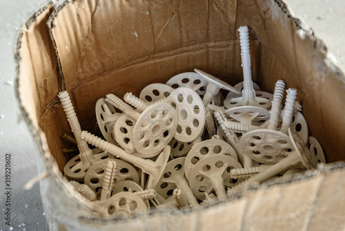Box of white plastic dowels for thermal insulation. © Natallia